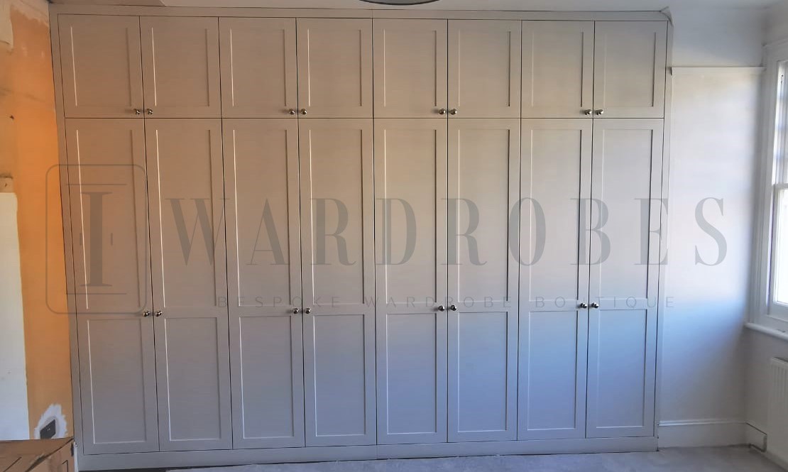 Bespoke shaker style spray painted wardrobe in a modern bedroom.