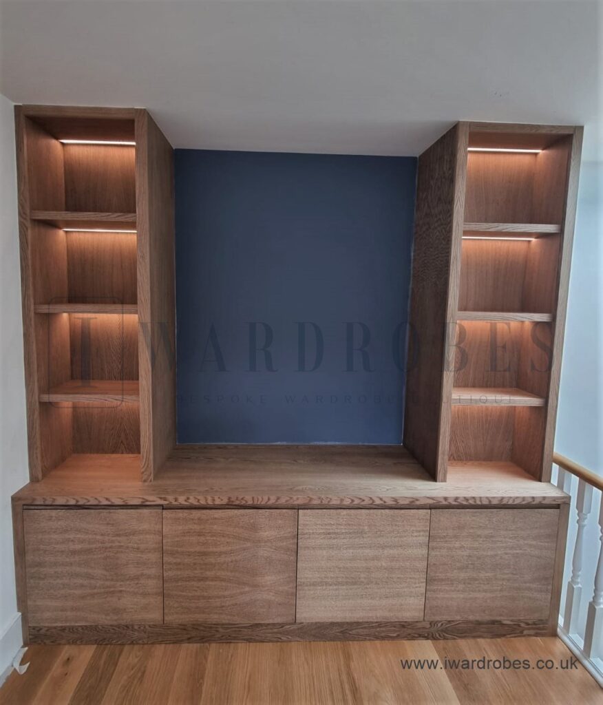 Modern bespoke wood veneer TV unit with open shelving and storage cabinets.