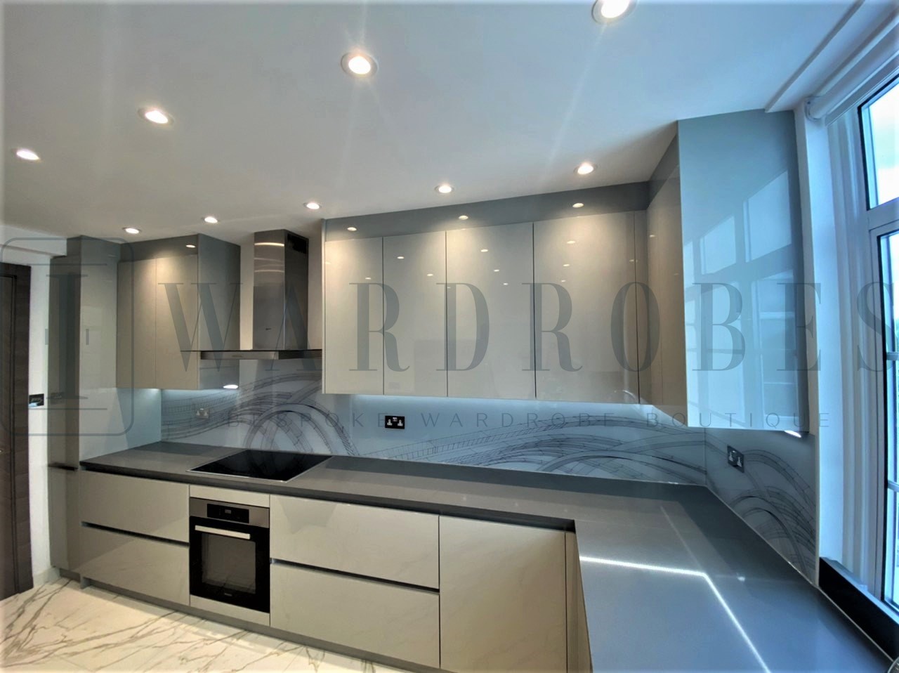 Modern high gloss fitted kitchen with sleek cabinetry and integrated appliances.