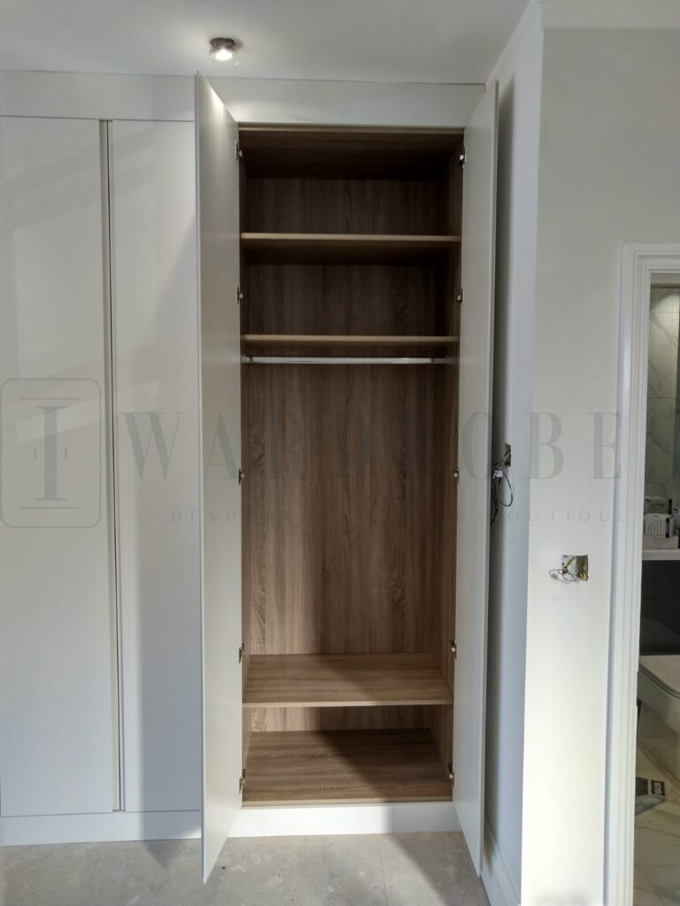 Custom built bedroom wardrobe with sloping ceiling design in London.